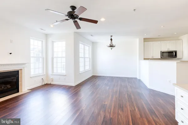 a view of empty room with wooden floor and fireplace
