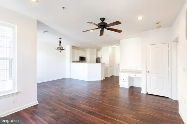 a view of a kitchen with wooden floor and window in the room