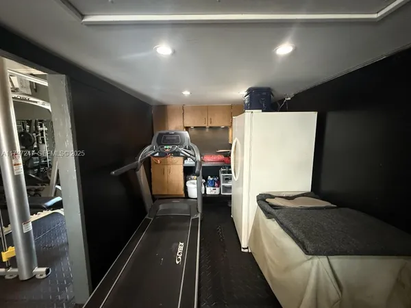 a kitchen with a refrigerator and a sink
