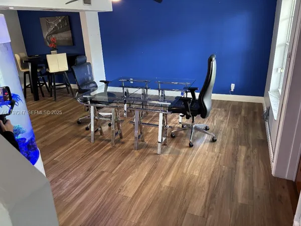 a view of a dining room with furniture and wooden floor