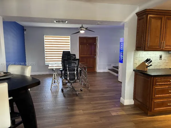 a view of a dining room with furniture and wooden floor