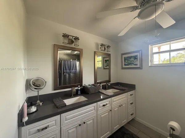 a bathroom with a toilet and a shower curtain