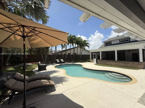 a view of a house with backyard and patio
