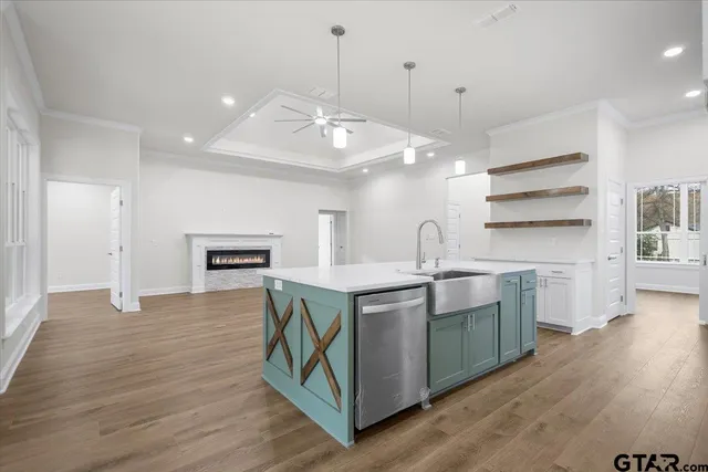 a kitchen with kitchen island a sink and a stove top oven