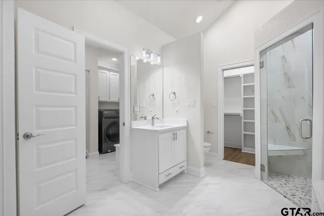 a white bath tub sitting next to a shower