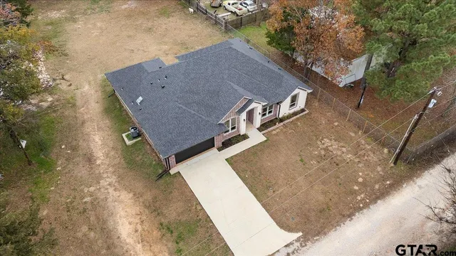a aerial view of a house with a yard