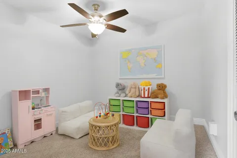 an empty room with a ceiling fan and window
