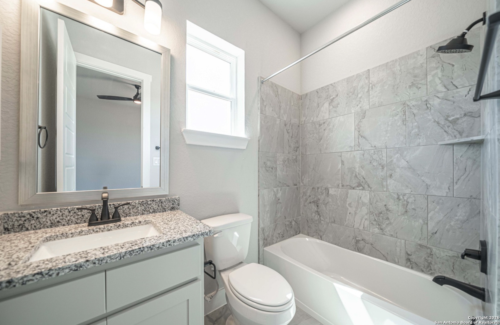302 Venado Oaks Rio Medina, TX 78066 - Photo 18 of 34 a bathroom with a granite countertop sink toilet and shower