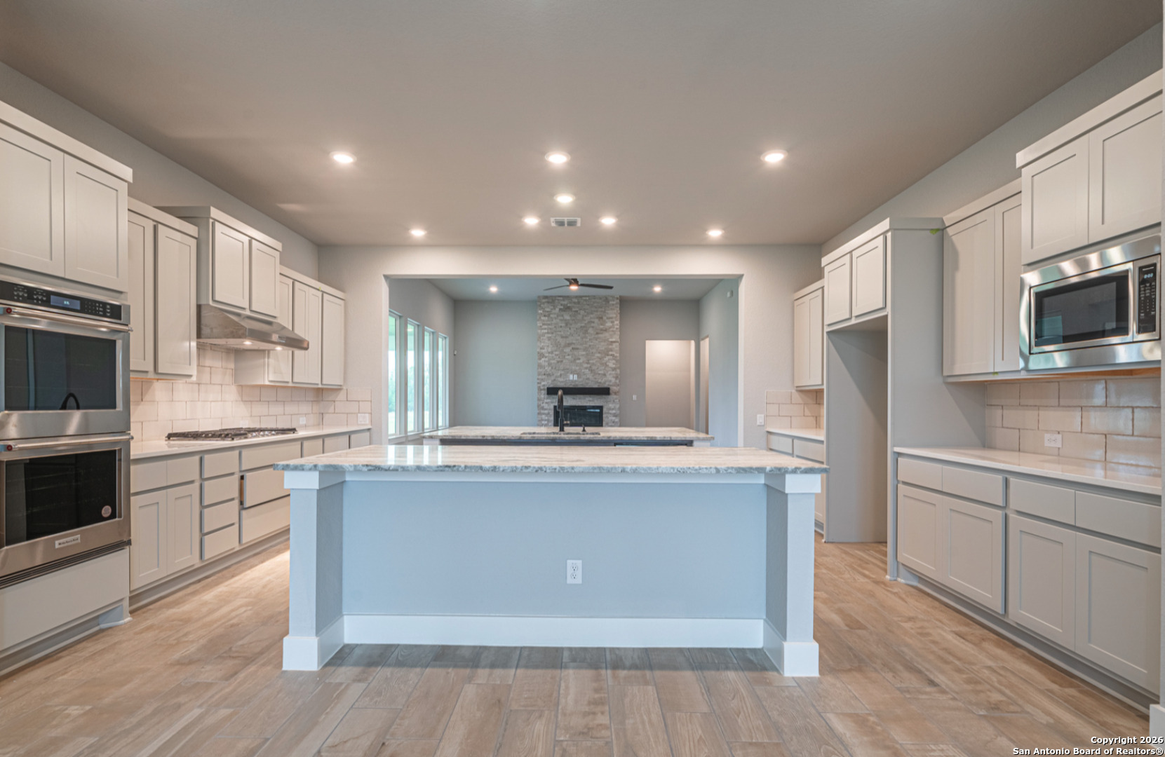 302 Venado Oaks Rio Medina, TX 78066 - Photo 7 of 34 a kitchen with stainless steel appliances granite countertop a stove top oven a sink and a refrigerator