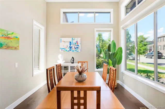 a view of a dining room with furniture window and wooden floor