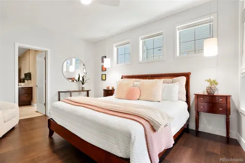 a bedroom with bed and wooden floor