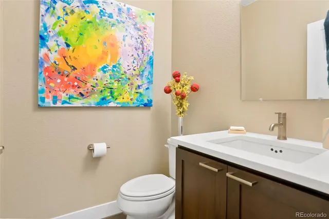 a bathroom with a sink mirror and toilet