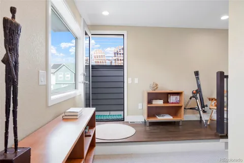a living room with furniture a rug and a window