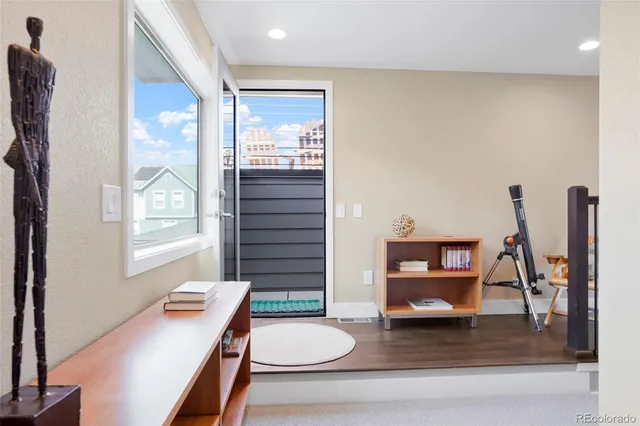 a living room with furniture a rug and a window