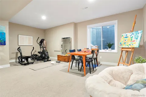 a living room with furniture a flat screen tv and a large window