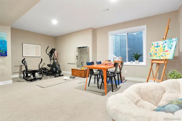 a living room with furniture a flat screen tv and a large window