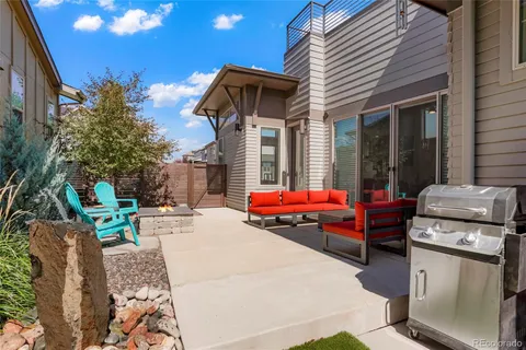 a view of a chair and tables in patio of the house