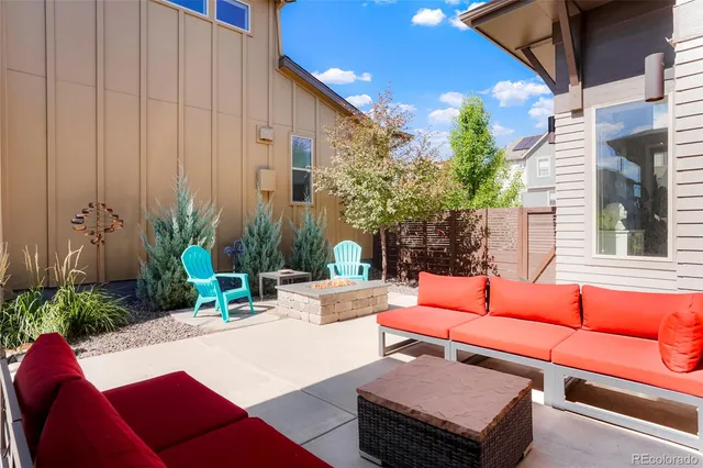 a outdoor space with patio couches a fireplace with potted plants