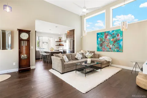 a living room with furniture and a painting on the wall