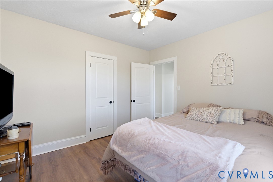 61 Mohawk Road Buckingham, VA 23921 - Photo 14 of 40 a bedroom with a bed and a chandelier