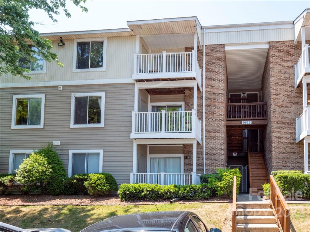 9523 University Terrace Drive, Unit J Charlotte, NC 28262 - Photo 1 of 18 a front view of a house with a yard