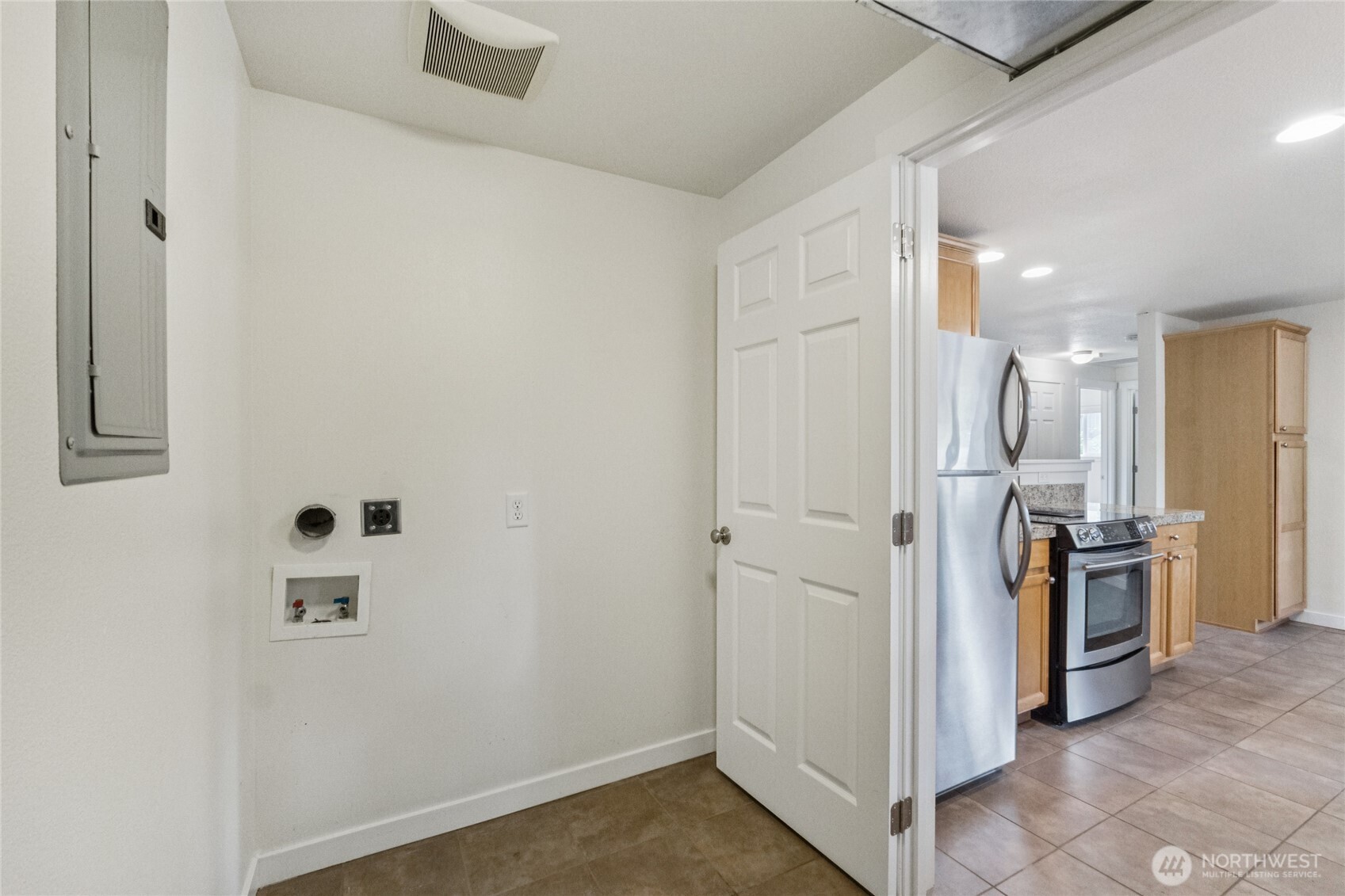 2405 B Street Steilacoom, WA 98388 - Photo 11 of 27 a view of a kitchen with refrigerator and wooden floor