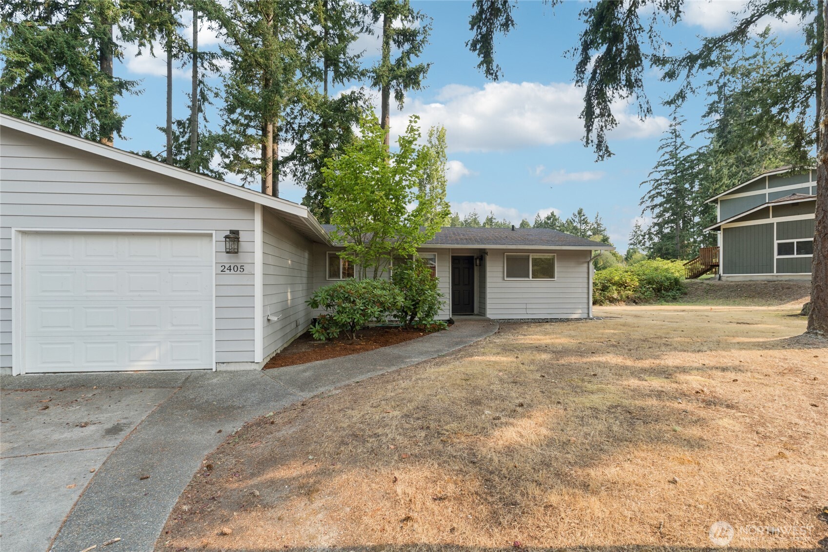 2405 B Street Steilacoom, WA 98388 - Photo 24 of 27 a front view of a house with a yard and garage