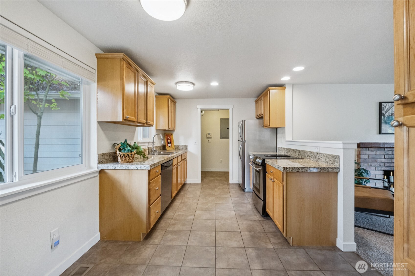 2405 B Street Steilacoom, WA 98388 - Photo 7 of 27 a kitchen with stainless steel appliances granite countertop a stove a sink and a refrigerator