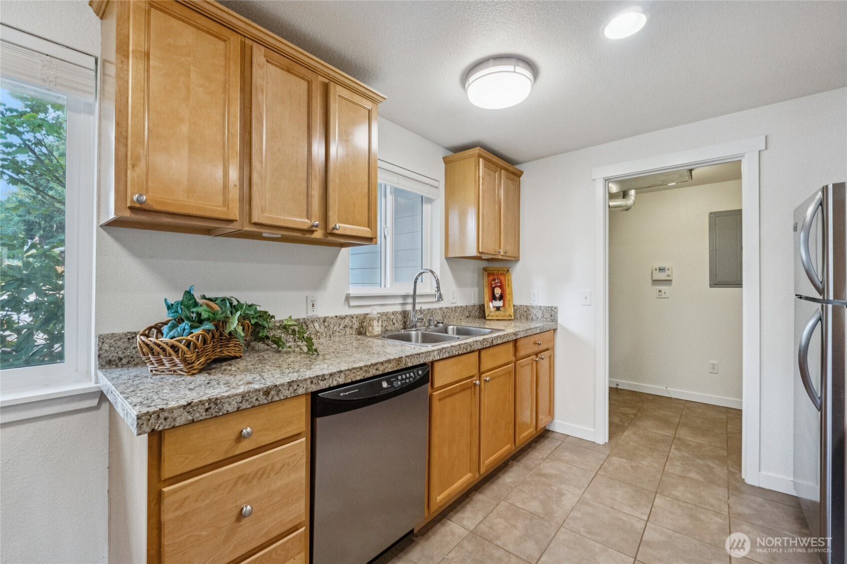2405 B Street Steilacoom, WA 98388 - Photo 8 of 27 a kitchen with stainless steel appliances granite countertop a sink and a refrigerator
