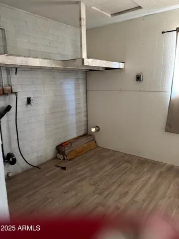 a room with a wooden floor and white door