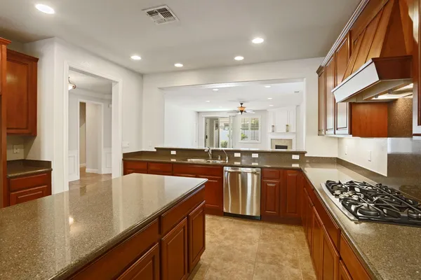 a kitchen with stainless steel appliances a sink stove and cabinets