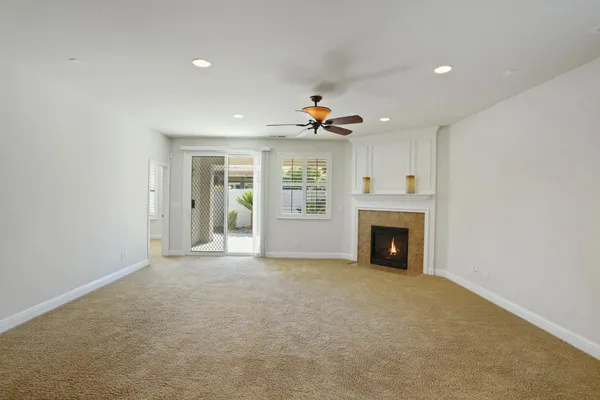 a view of an empty room with a fireplace