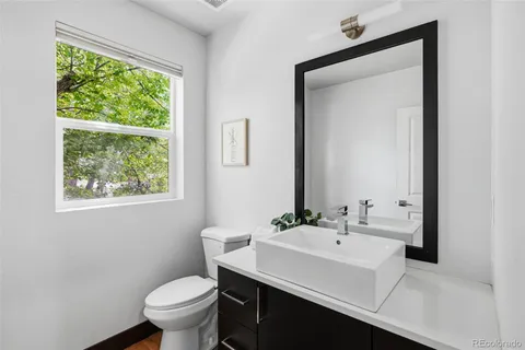 a bathroom with a sink toilet and a mirror