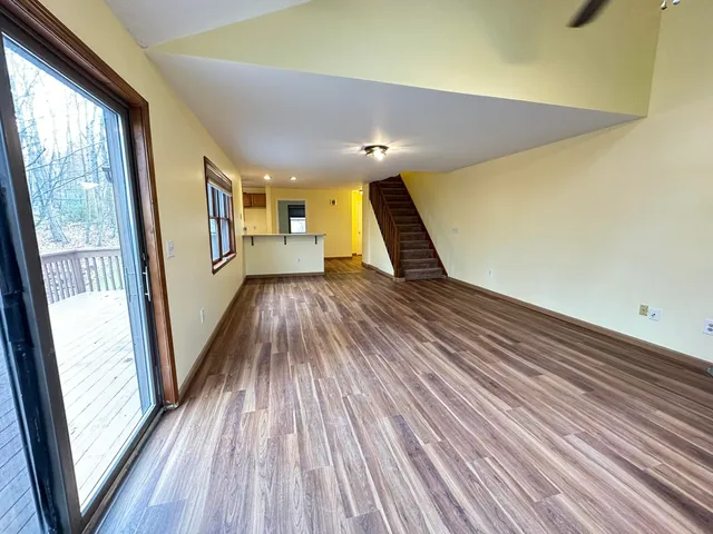 a view of a hallway with wooden floor