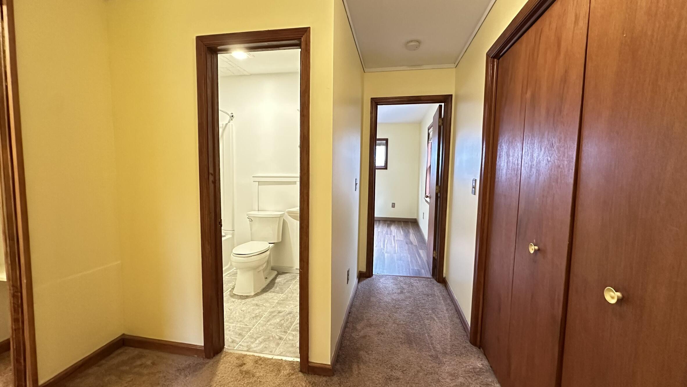 227 Image Drive Scotrun, PA 18355 - Photo 23 of 39 a view of a hallway with wooden floor and a bathroom