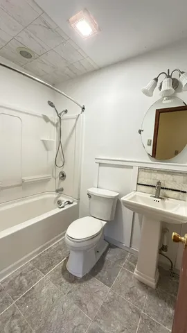 a bathroom with a toilet and a sink
