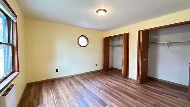 a view of a room with stairs and wooden floor