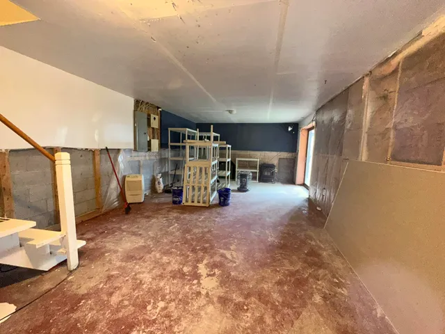 a view of empty room with wooden floor and windows