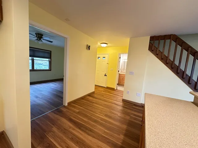 a view of a hallway view with wooden floor and staircase