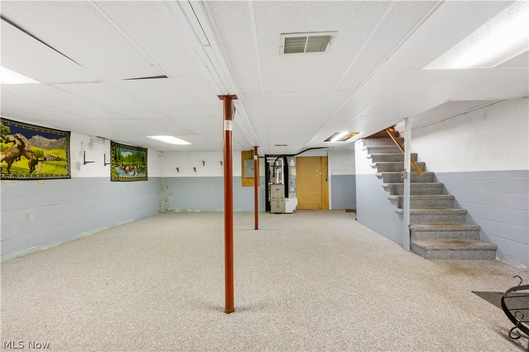 4001 South Cleveland Massillon Road Barberton, OH 44203 - Photo 15 of 25 Finished below grade area featuring heating unit, carpet flooring, and a drop ceiling