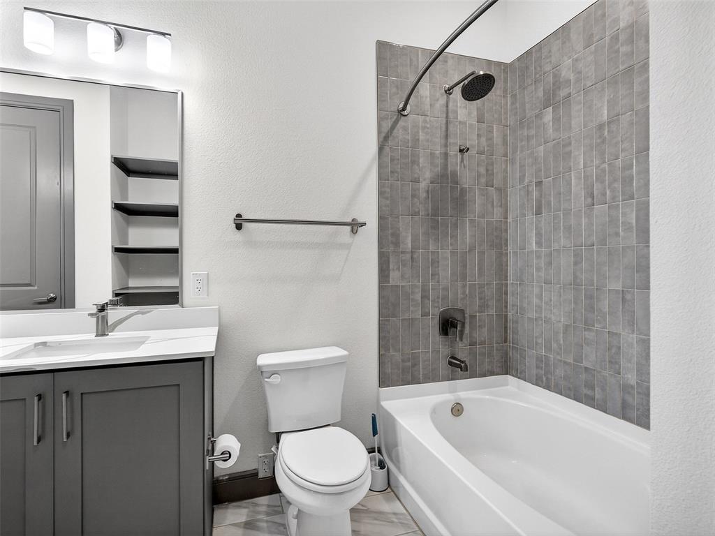 2700 Old Denton Road, Unit 3370 Carrollton, TX 75007 - Photo 19 of 35 a bathroom with a granite countertop bathtub shower sink vanity and toilet