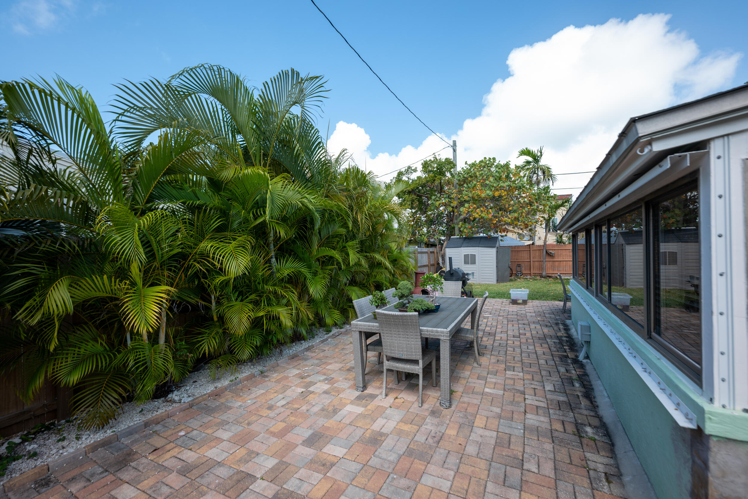 3001 Riviera Drive Key West, FL 33040 - Photo 11 of 17 a view of a patio with a table and chairs under an umbrella