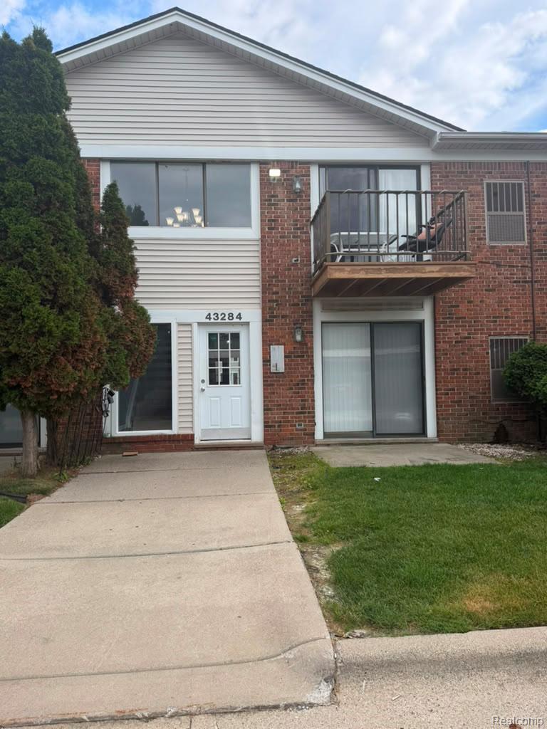 43284 Mound Road Sterling Heights, MI 48314 - Photo 15 of 19 Brick and siding facade featuring a second-story balcony