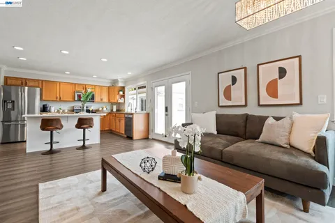 a living room with furniture kitchen view and a table
