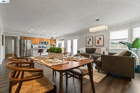 a view of a dining room with furniture and wooden floor