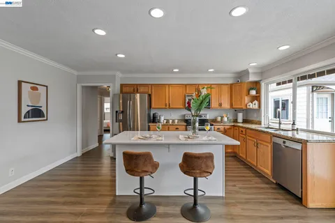 a kitchen with stainless steel appliances granite countertop a stove and cabinets