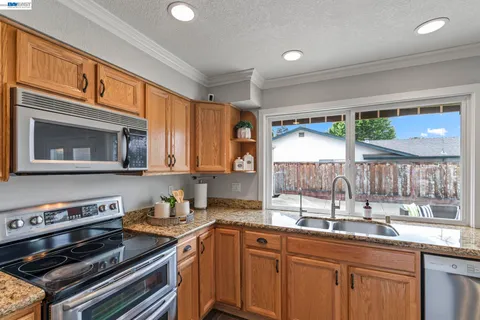 a kitchen with a stove a sink and a microwave