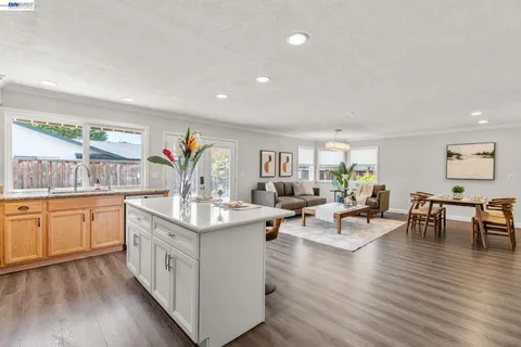 a living room with granite countertop furniture and wooden floor