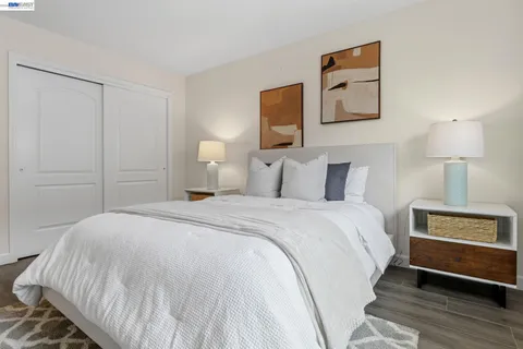 a bedroom with a bed and a night stand