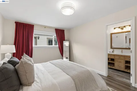 a bedroom with a bed and a mirror